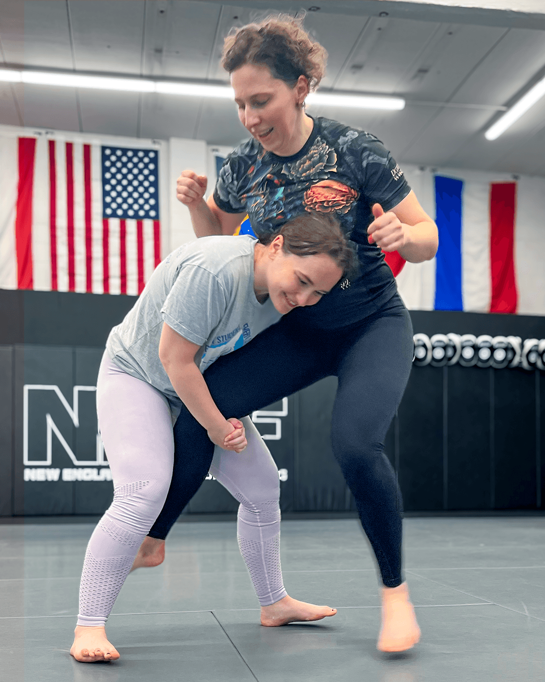 Two women drilling self-defense entries.