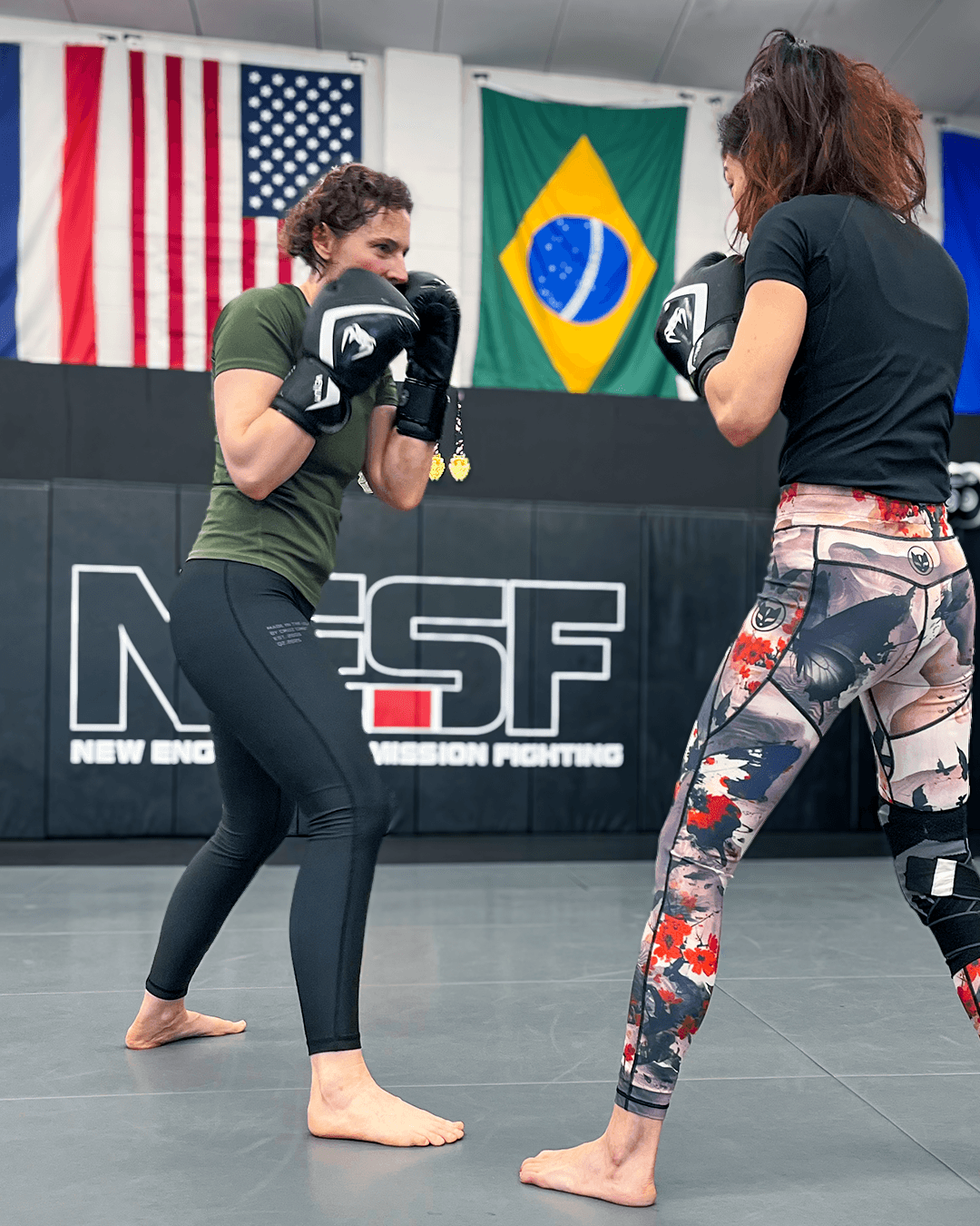 Two women practicing self-defense scenarios.