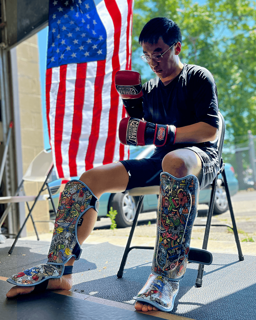 Assistant instructor Alex Tsang sitting on the mats.