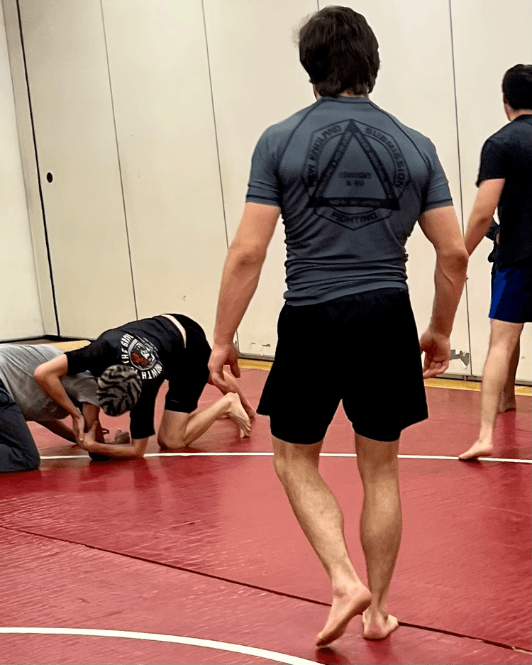 Assistant instructor wearing branded rash guard.