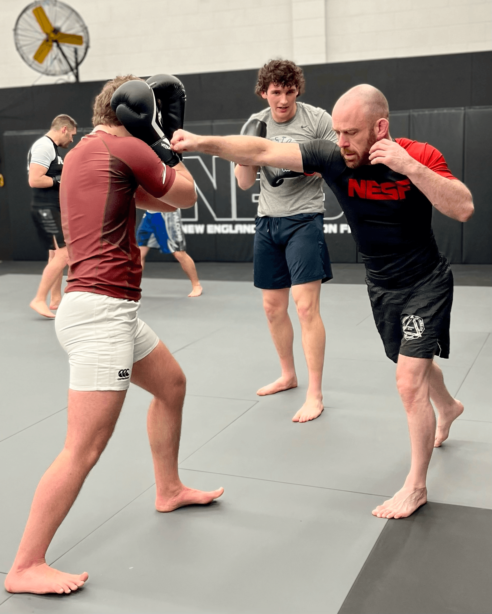 Head instructor teaching students to punch.