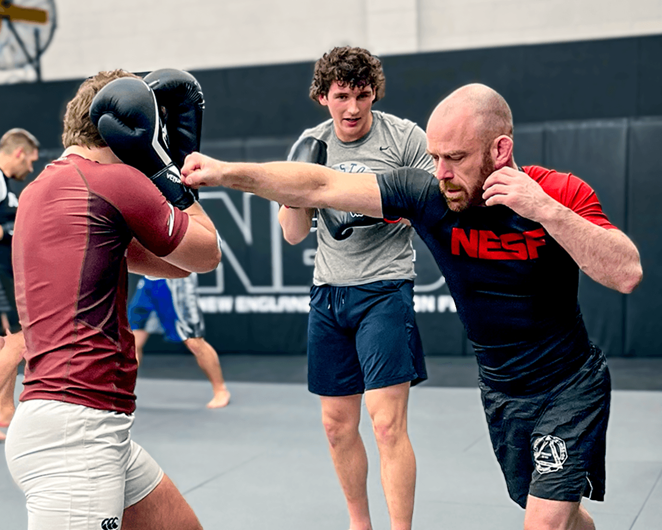 Head instructor teaching students to punch.