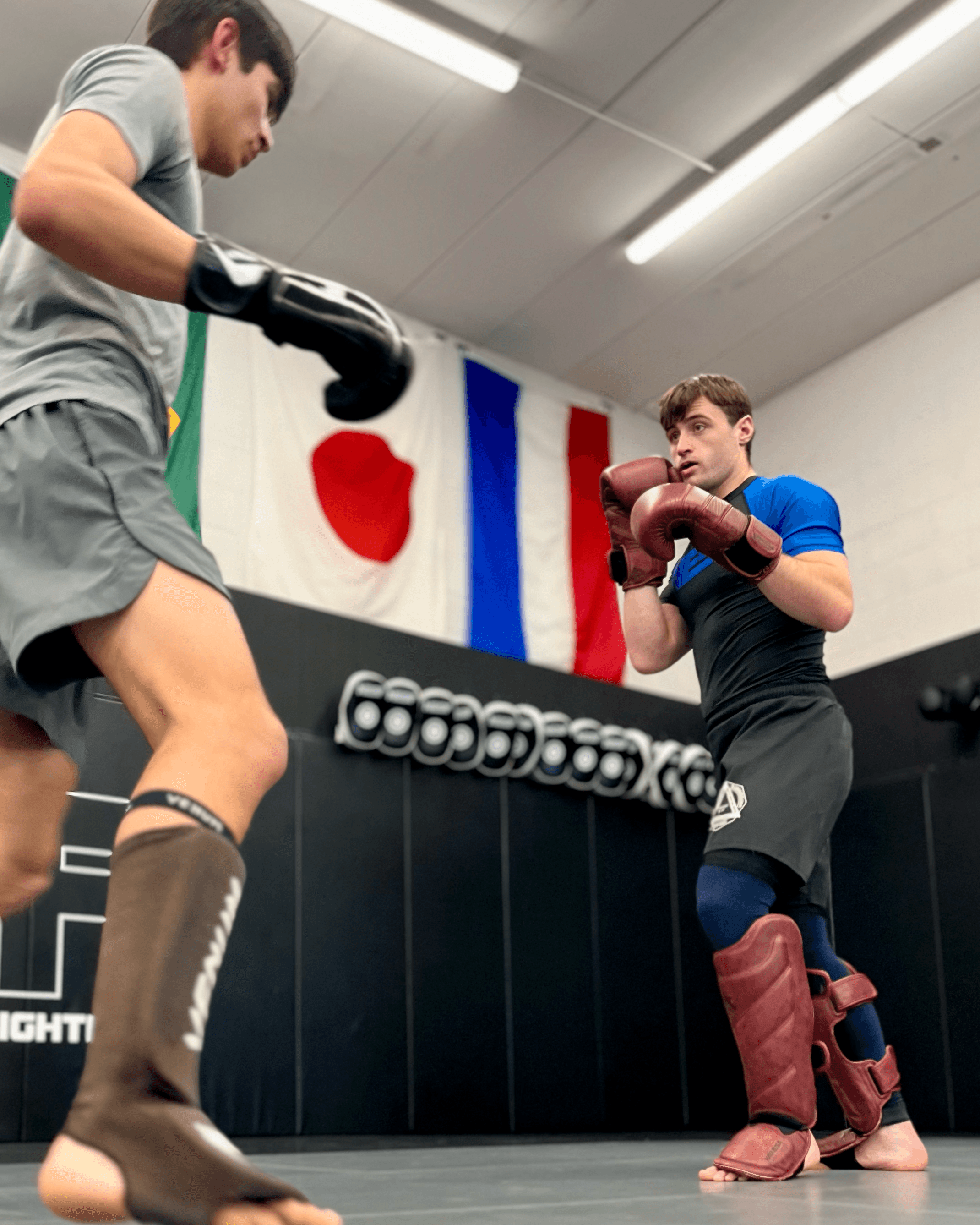 Two students doing mma sparring.