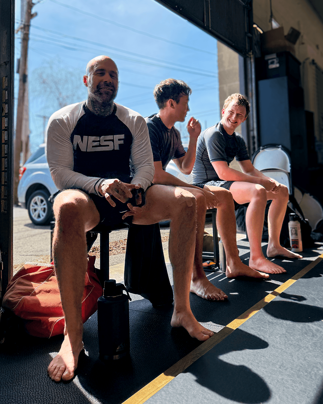 Student sitting in front of the garage door at Boston Submission Fighting