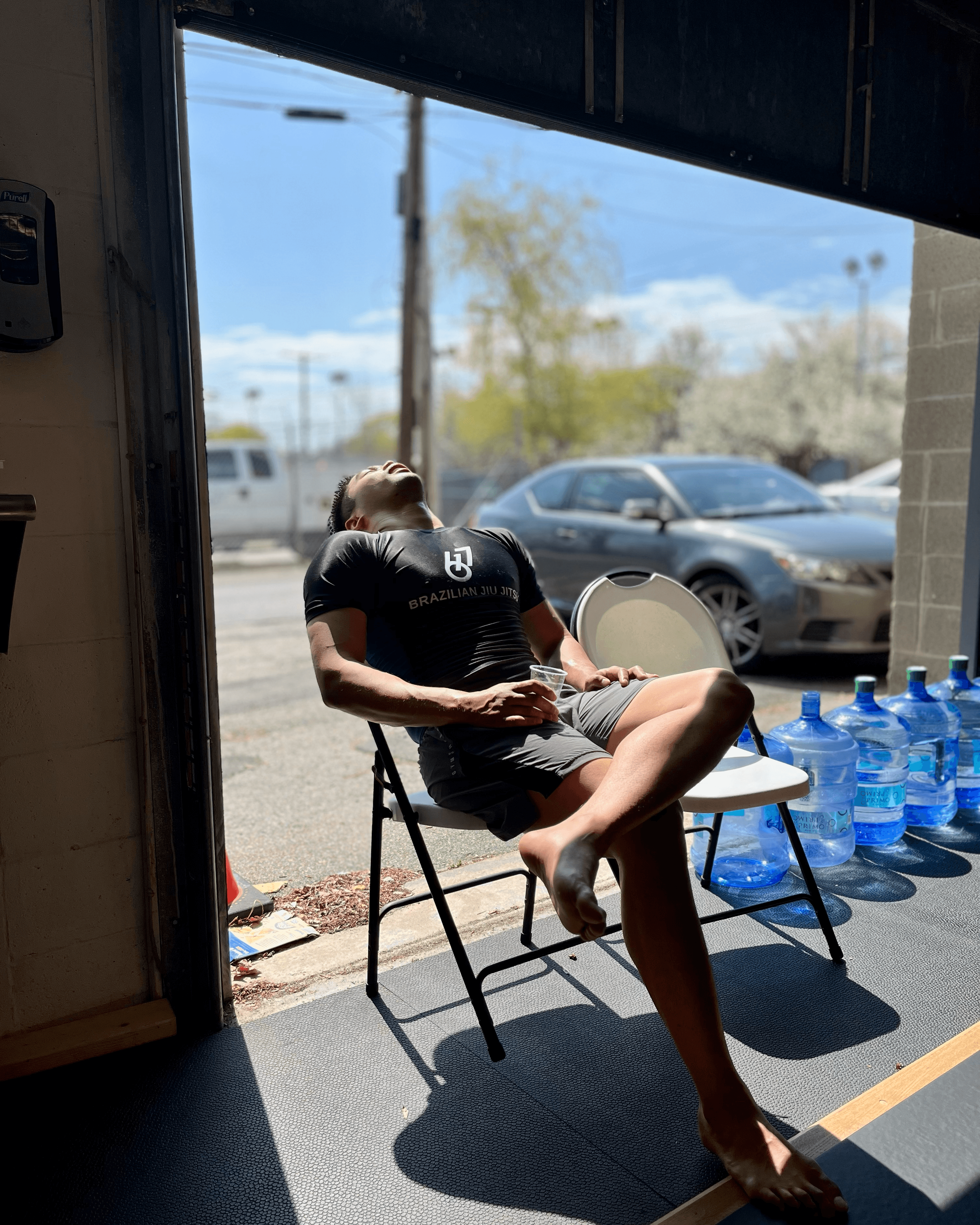 Student sitting near garage door with their head in the sunshine.