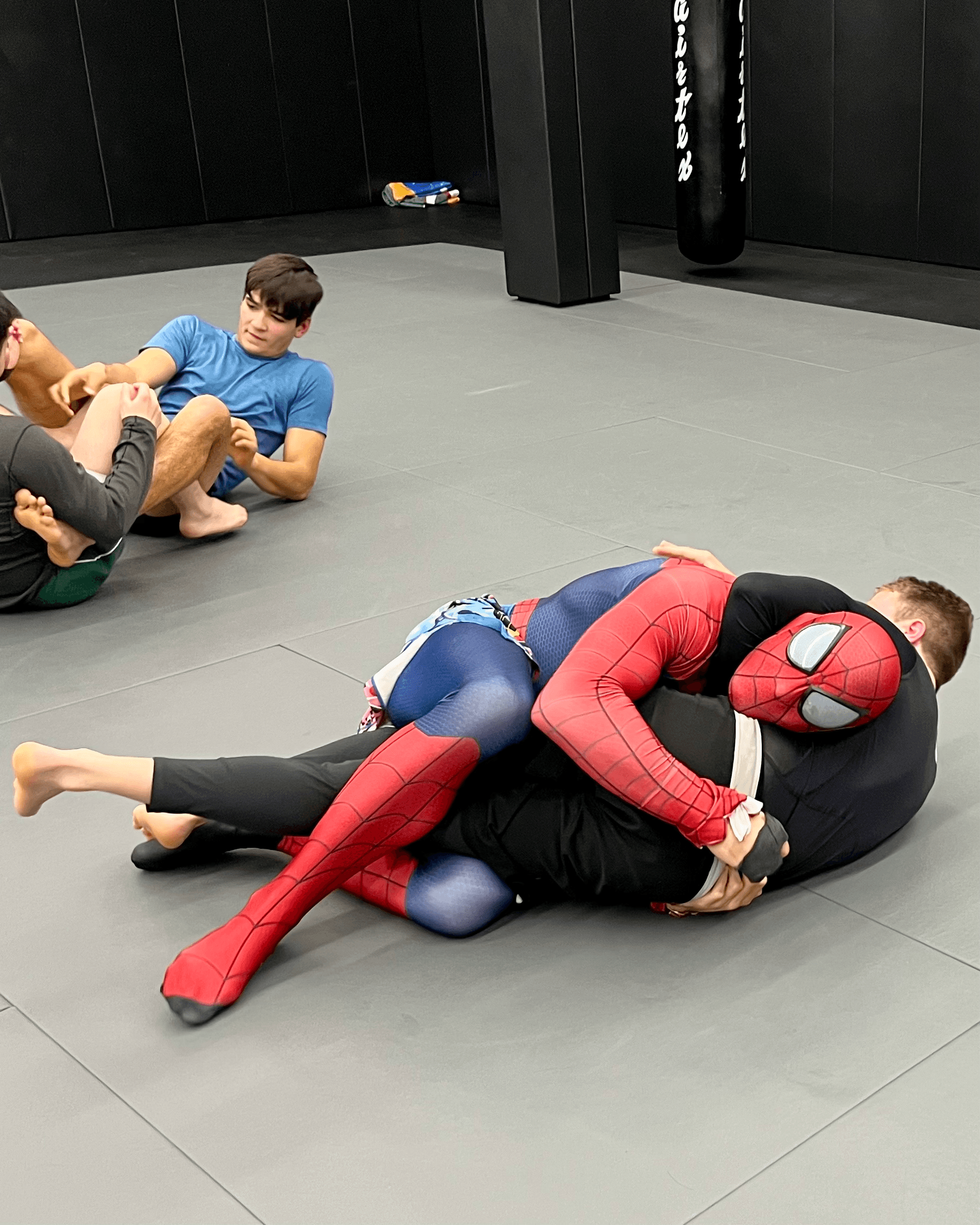 Student rolling in a Spiderman costume.