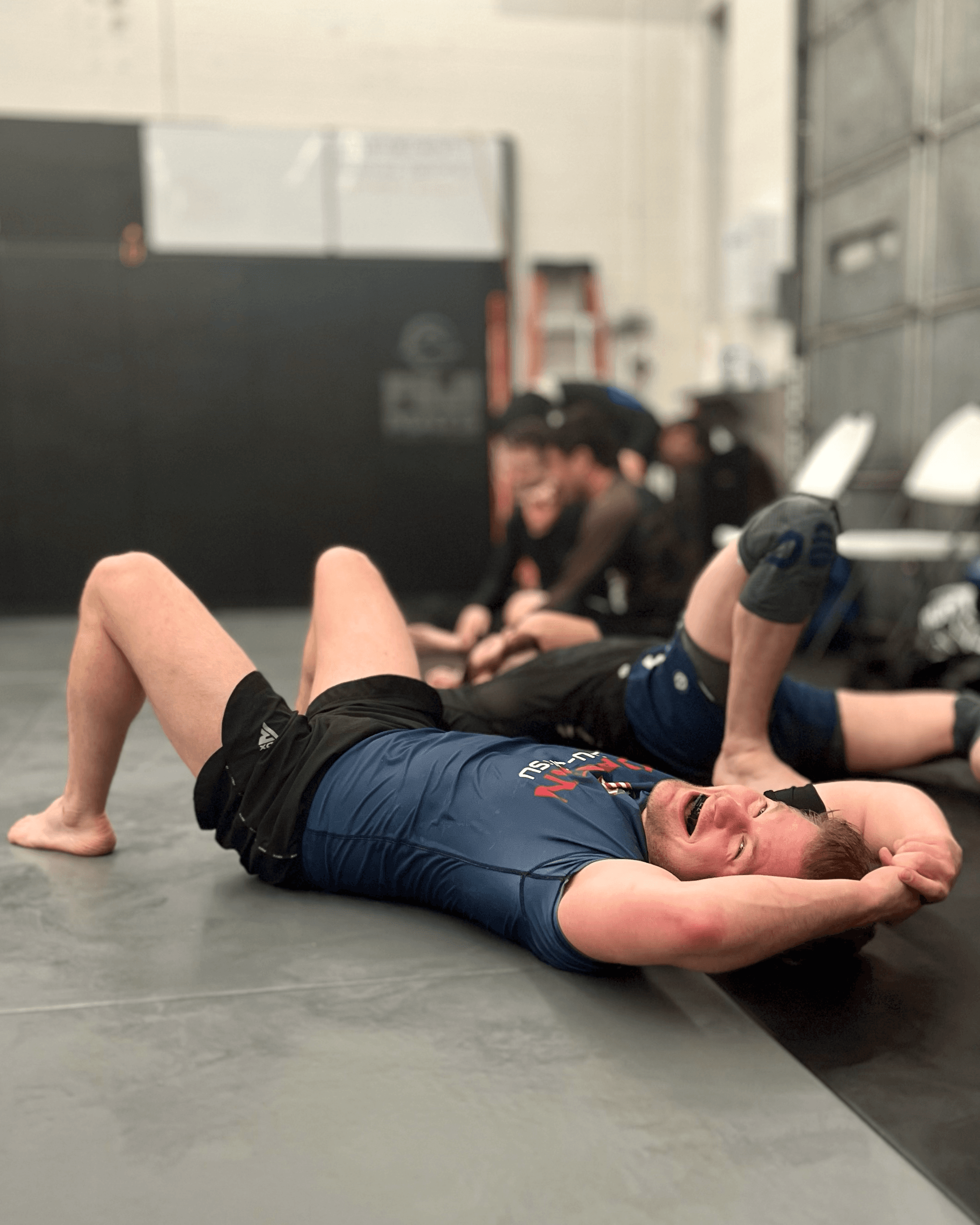 Student laying down after hard Jiu-Jitsu round.