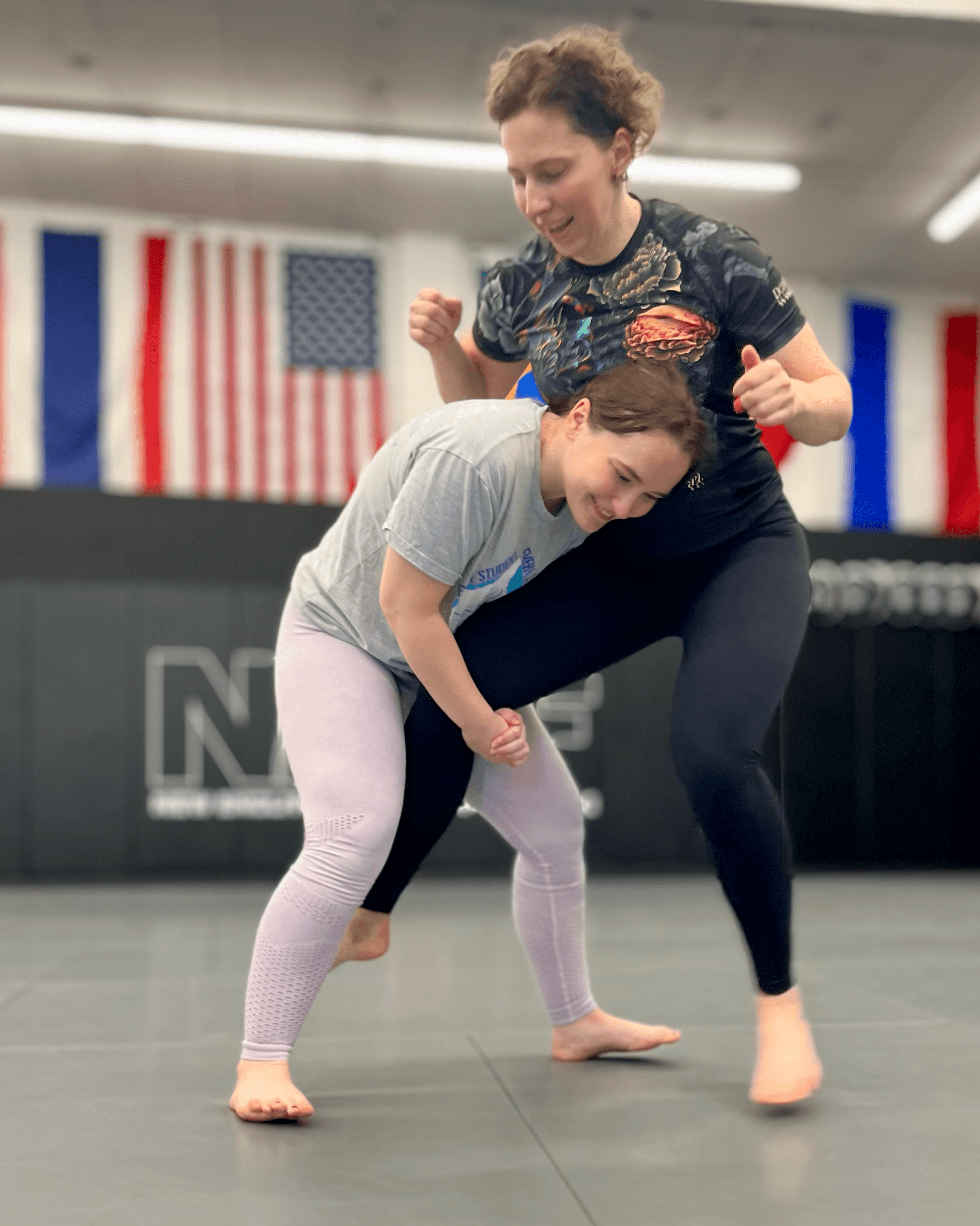 Women safely training wrestling technique.